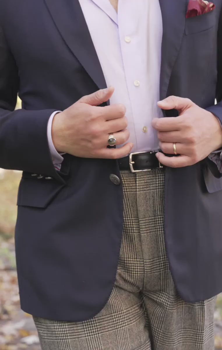 Looping video showing a model wearing a black dress belt