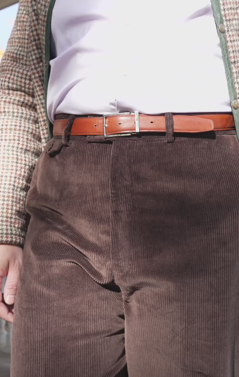 Looping video of model wearing a medium brown belt