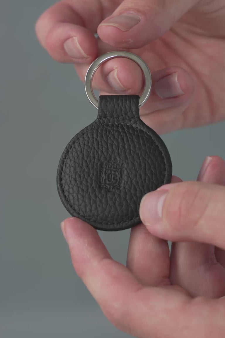 Looping video of a black leather key fob. 