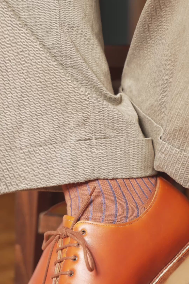 Looping video of a pair of shadow stripe socks in lifestyle settings