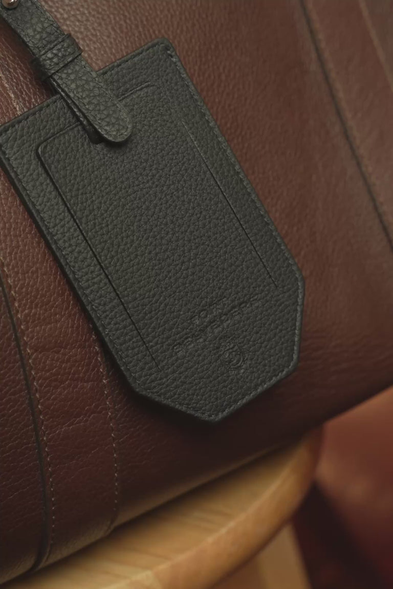 Looping video of a Fort Belvedere black Togo leather luggage tag