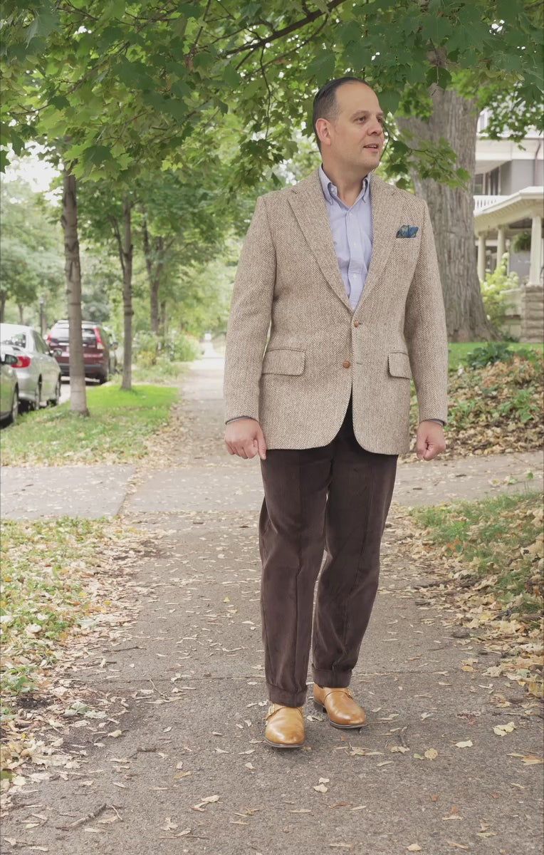 Lifestyle shot of Sven Raphael Schneider walking outside wearing a sport coat outfit with the Dark Brown Corduroy Trousers by Fort Belvedere