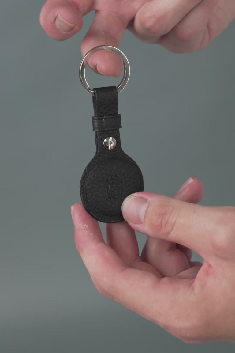 Looping video of a black leather AirTag holder. 