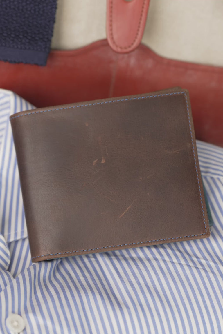 Looping video of a blue and brown leather wallet