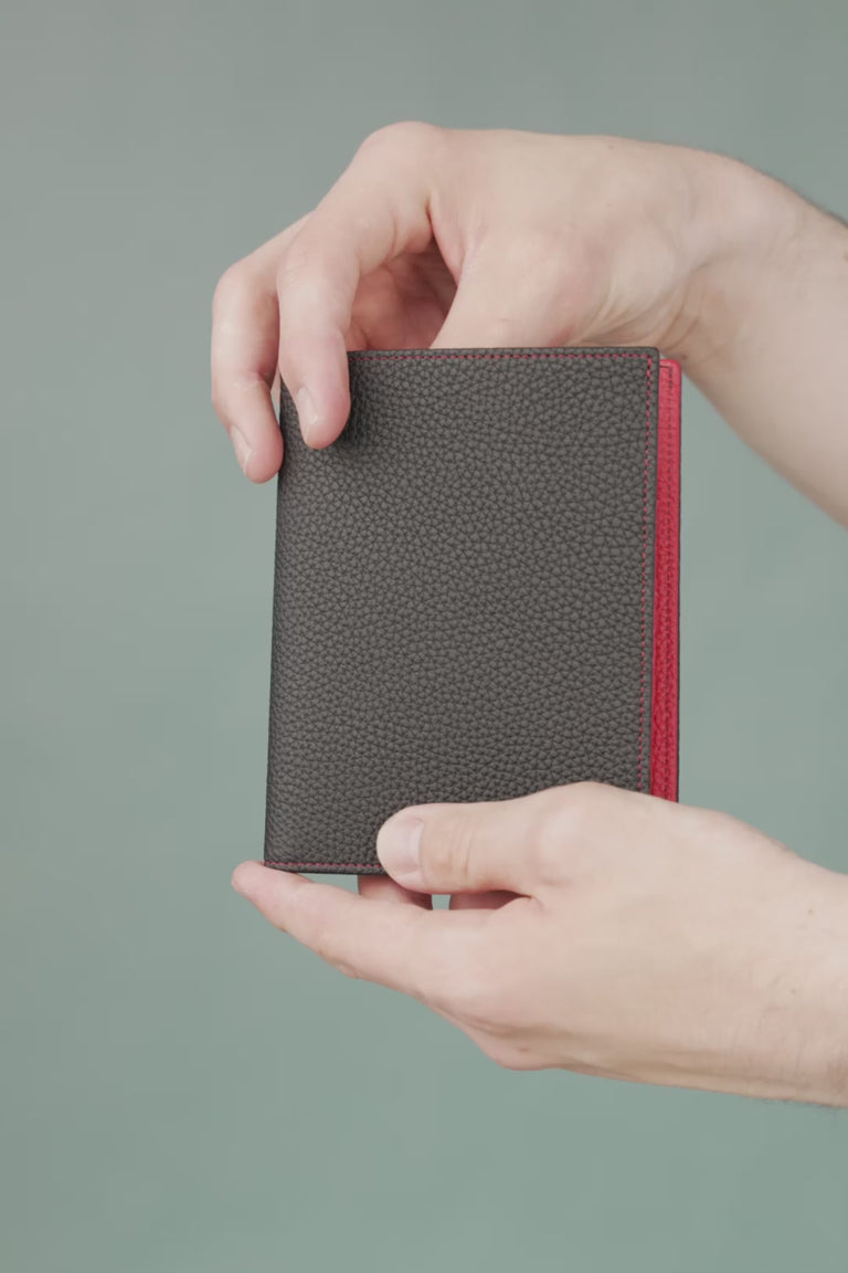 Looping video of a black and red passport holder
