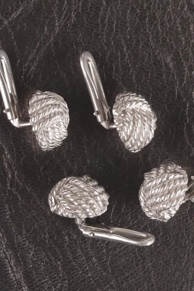 Looping video of silver colored monkey's fist knot shirt studs
