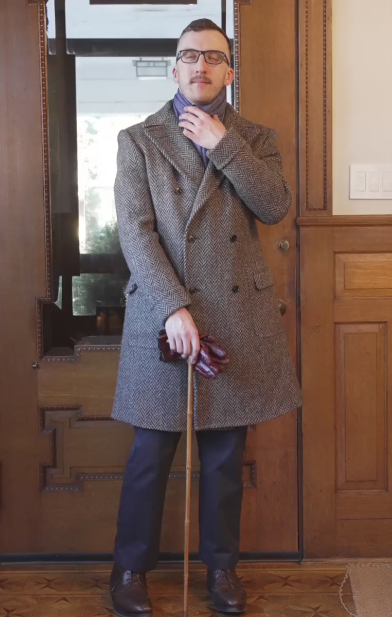 Blue herringbone scarf worn with a herringbone polo coat