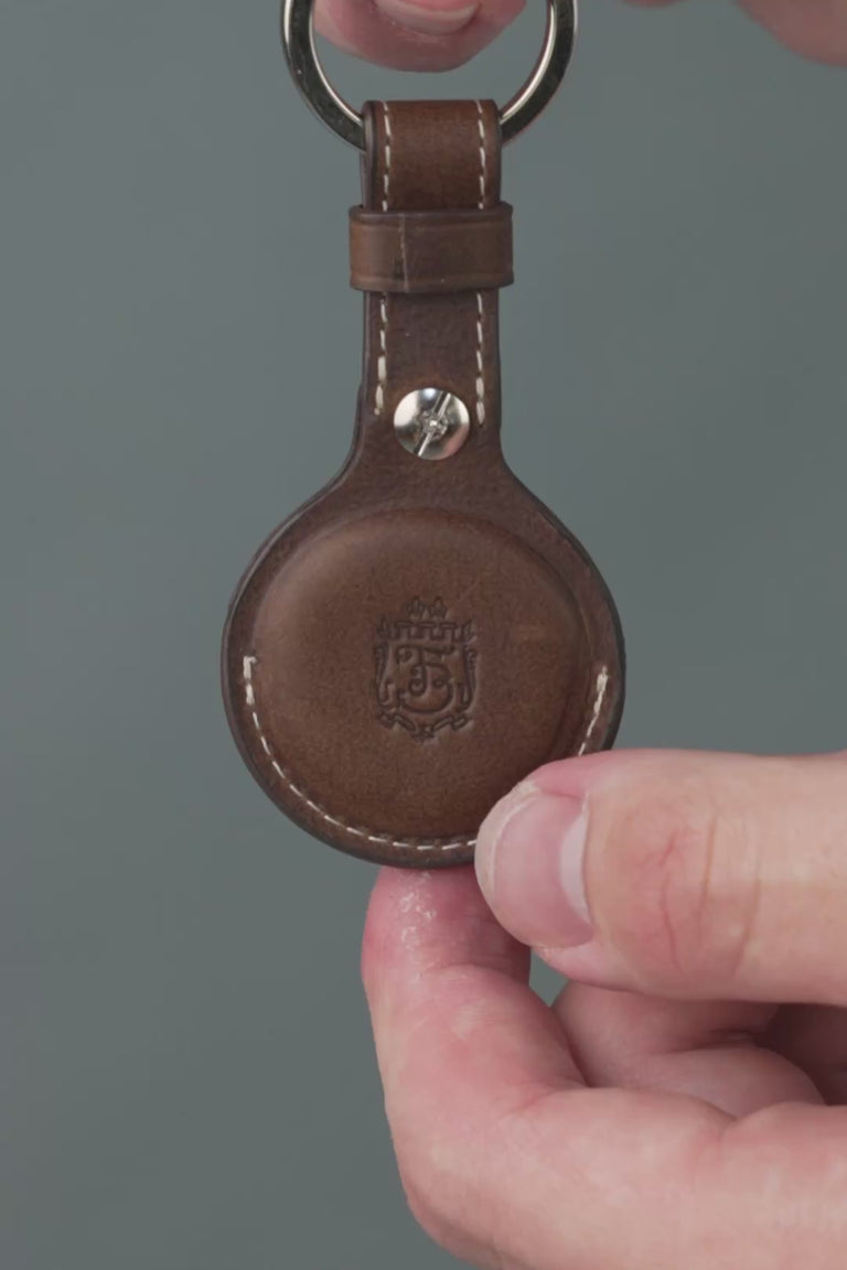 Dark brown leather AirTag holder looping video. 