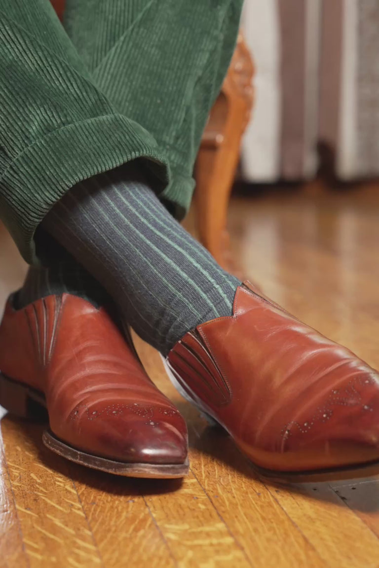 Looping video of a pair of shadow stripe socks in lifestyle settings