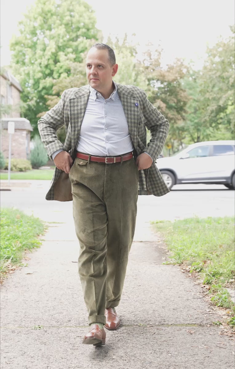 Lifestyle shot of Sven Raphael Schneider walking outside wearing a sport coat outfit with the Khaki Drab Corduroy Trousers by Fort Belvedere