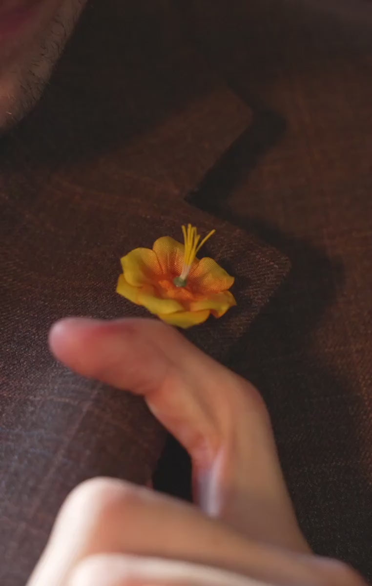 Orange boutonniere worn with a brown jacket