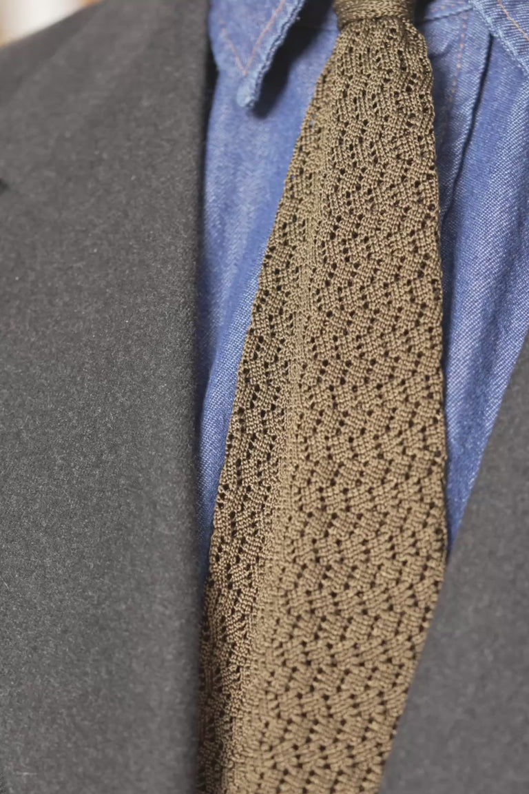 Looping images of an olive green silk knit zigzag tie