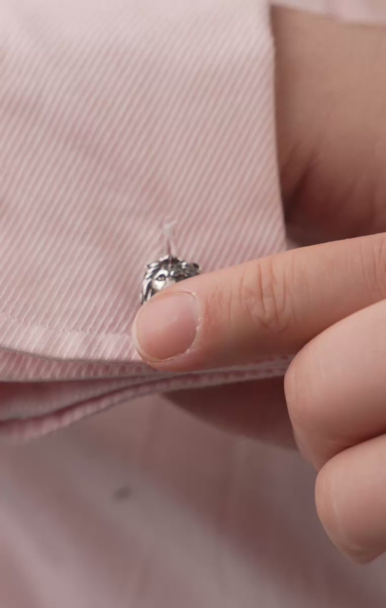 A pair of Lion & Gazelle Blackened Sterling Silver Cufflinks on a pink shirt cuff