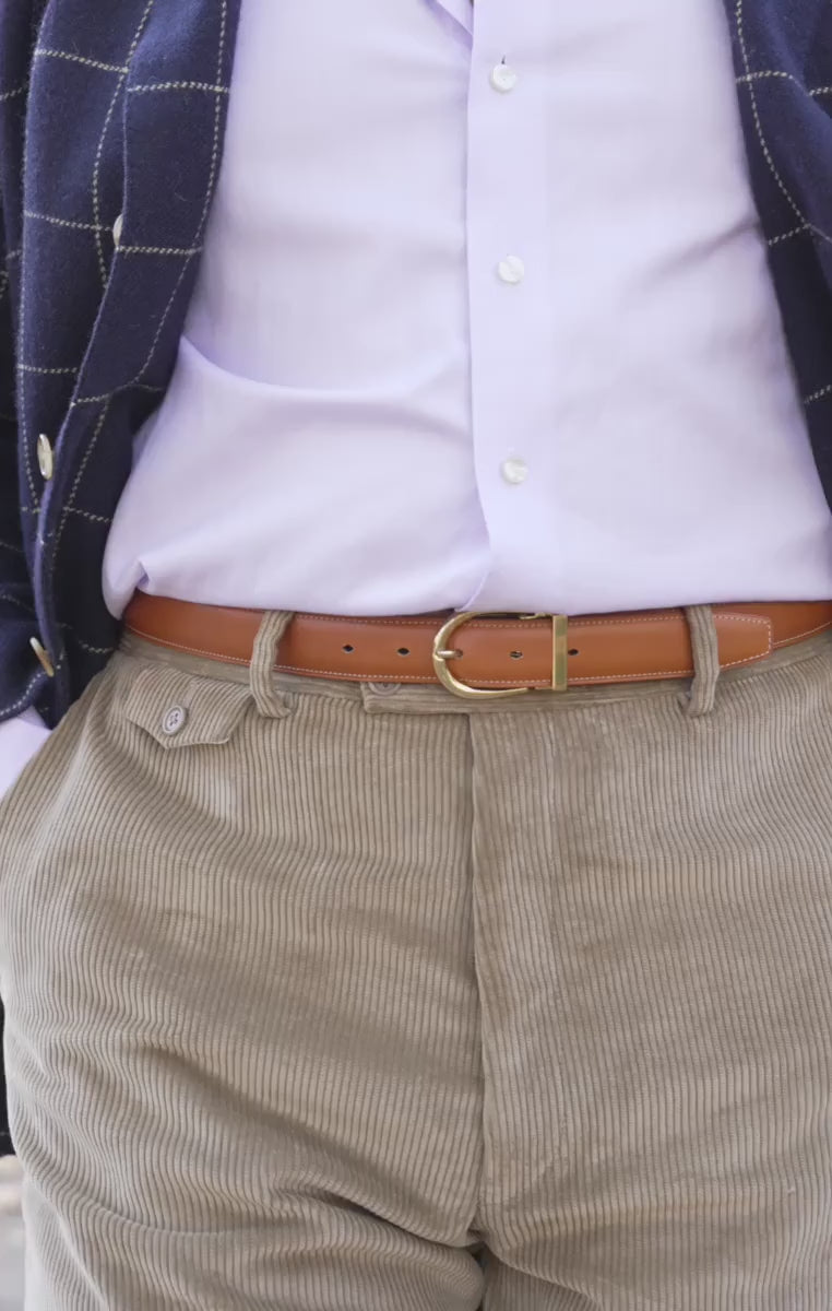 A model wears a tan belt in a looping video