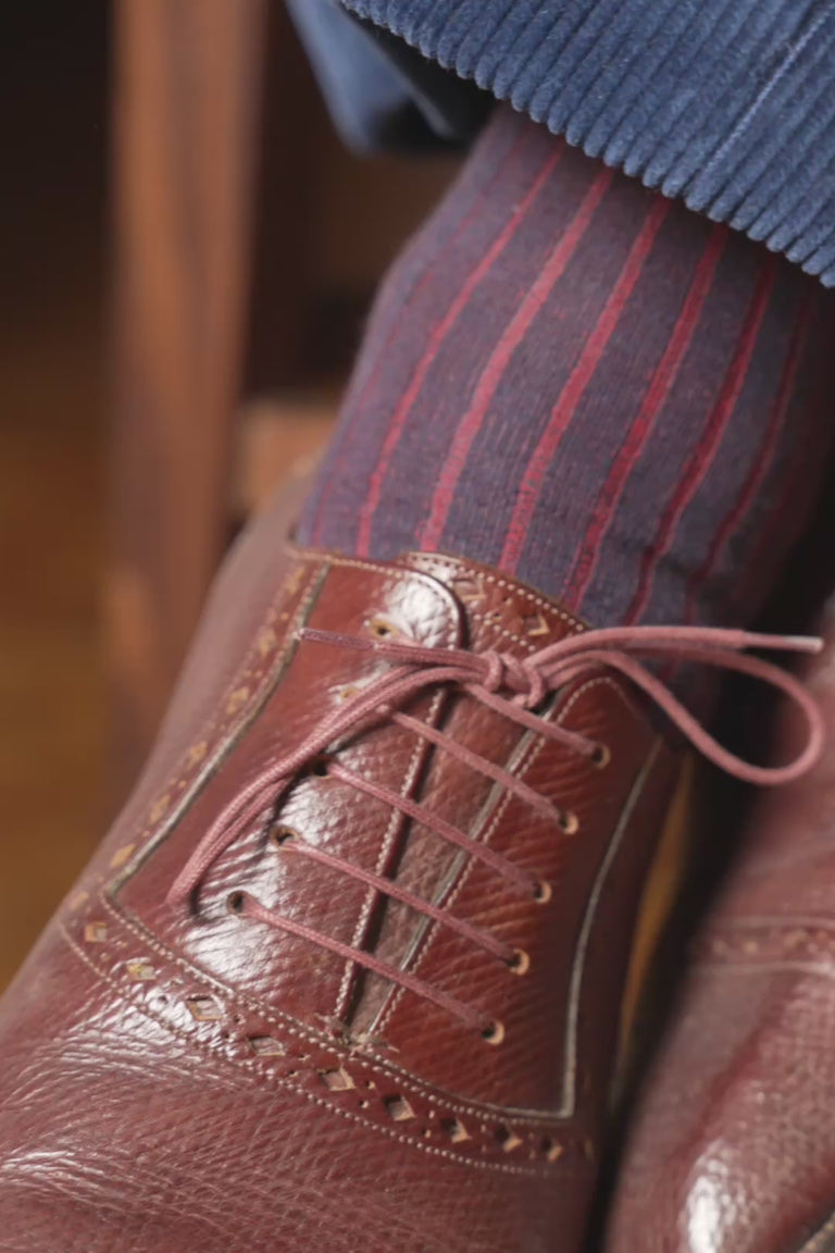 Looping video of a pair of shadow stripe socks in lifestyle settings
