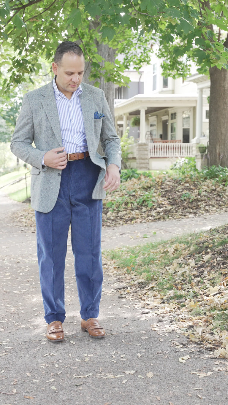 Sven Raphael Schneider walking in slow motion with blue Stancliffe corduroy pants