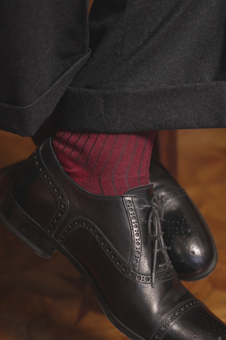 Looping video of red and gray striped socks in lifestyle settings