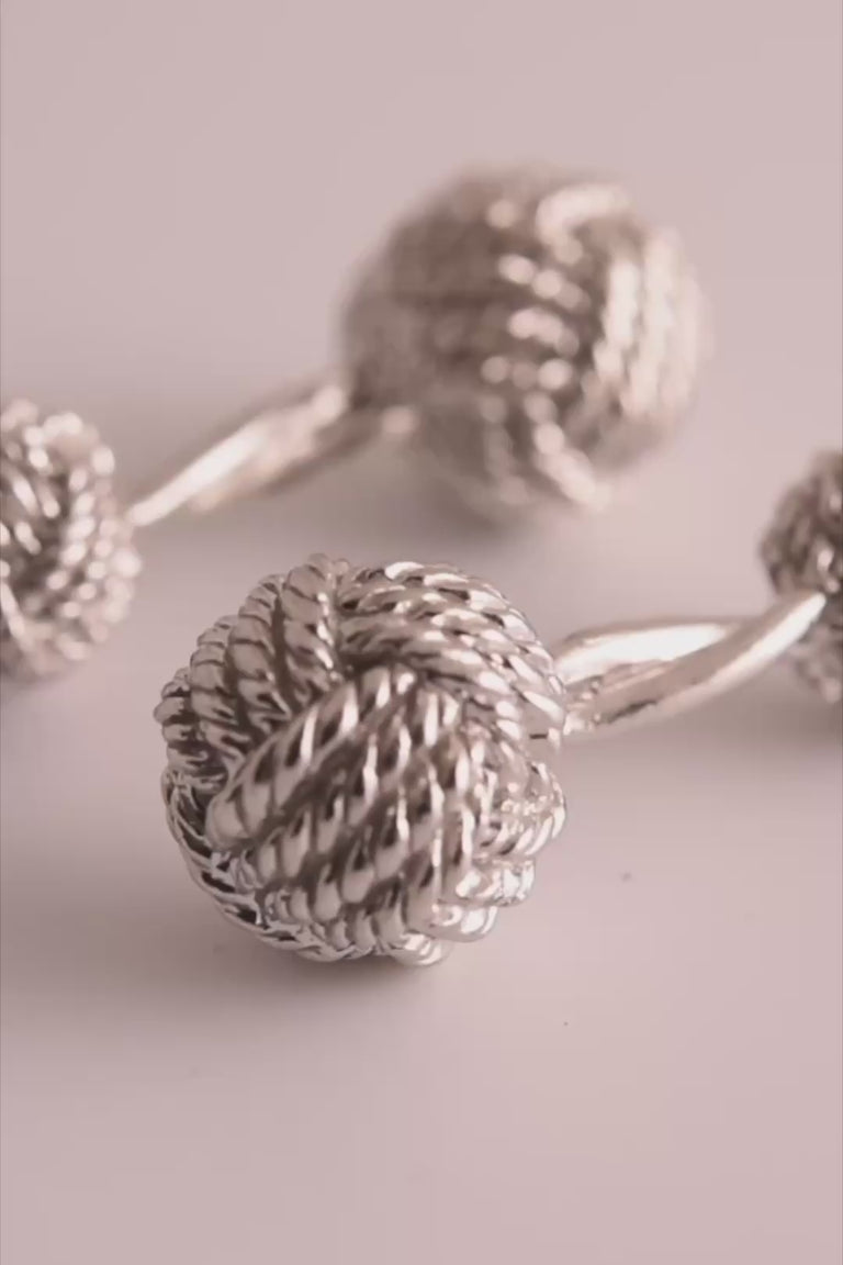 Looping video of silver colored monkey's fist knot cufflinks
