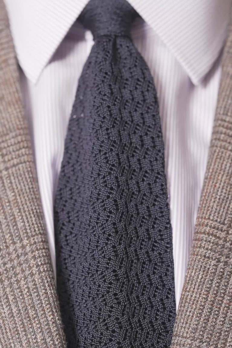 Looping images of a midnight blue silk knit zigzag tie